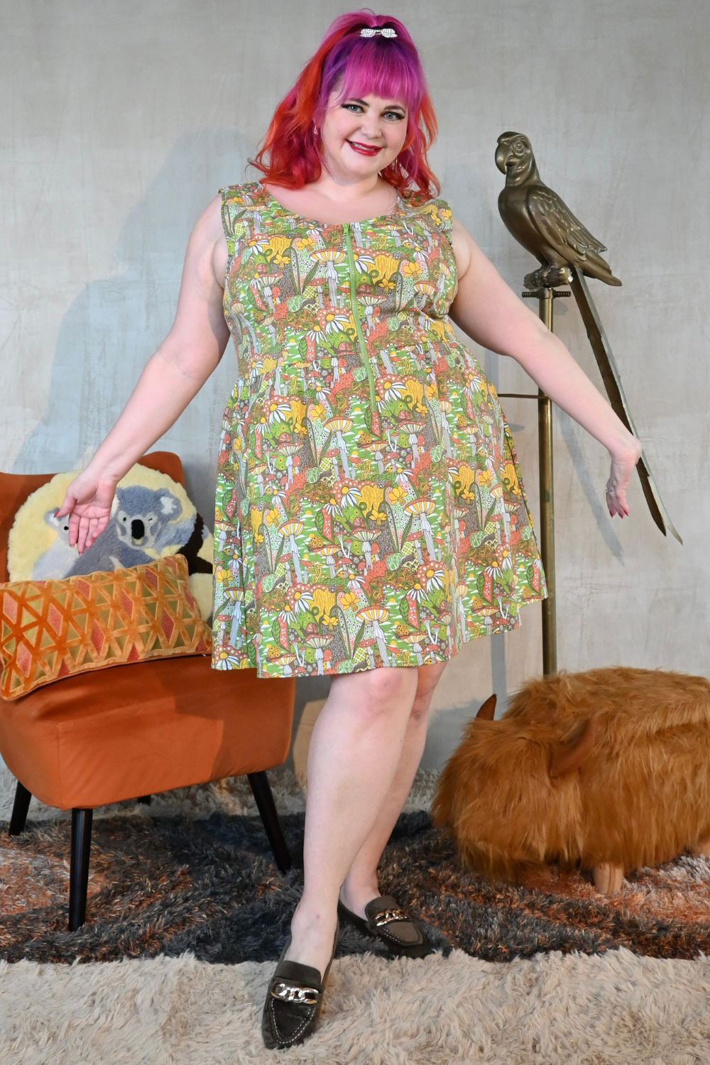 Happy pink-haired plus-size model in zip-front mushroom print cotton sleeveless dress