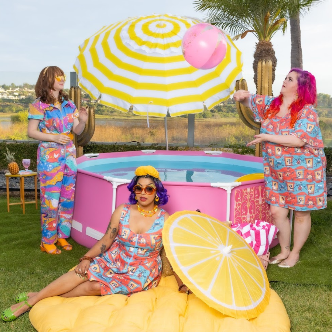 3 models playing in the sun in colorful light cotton clothing with colorful prints