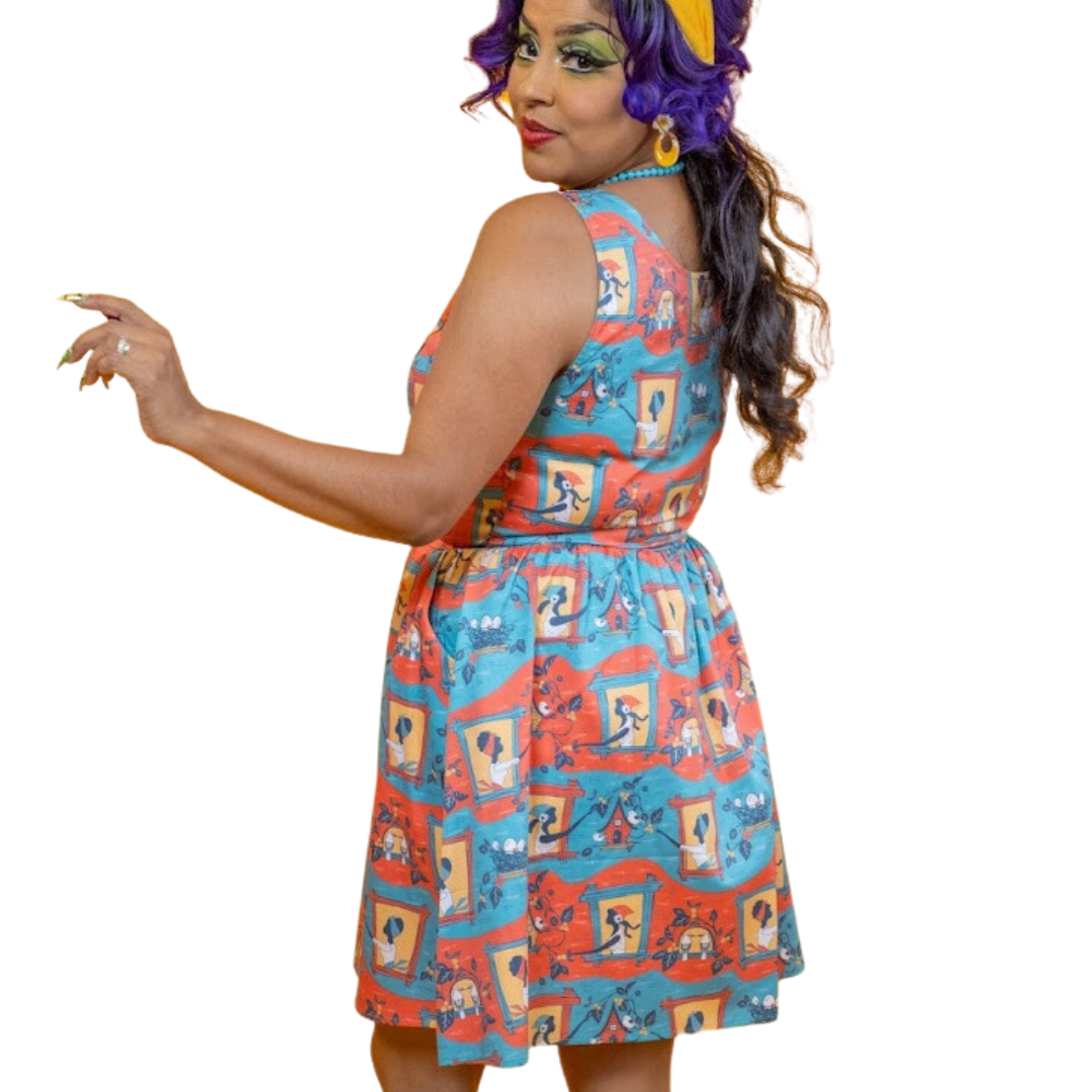 Back view of red and blue fit and flare dress featuring ladies feeding birds and picking berries