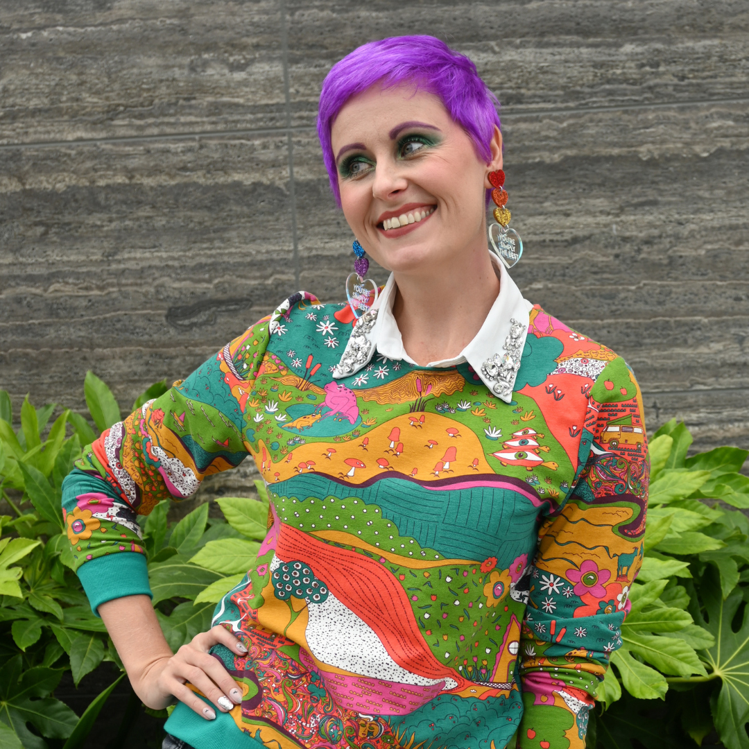 Pretty model in bright colored printed sweatshirt, close up