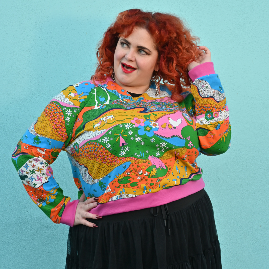 Red-haired model in rainbow animal print sweatshirt in rainbow colors