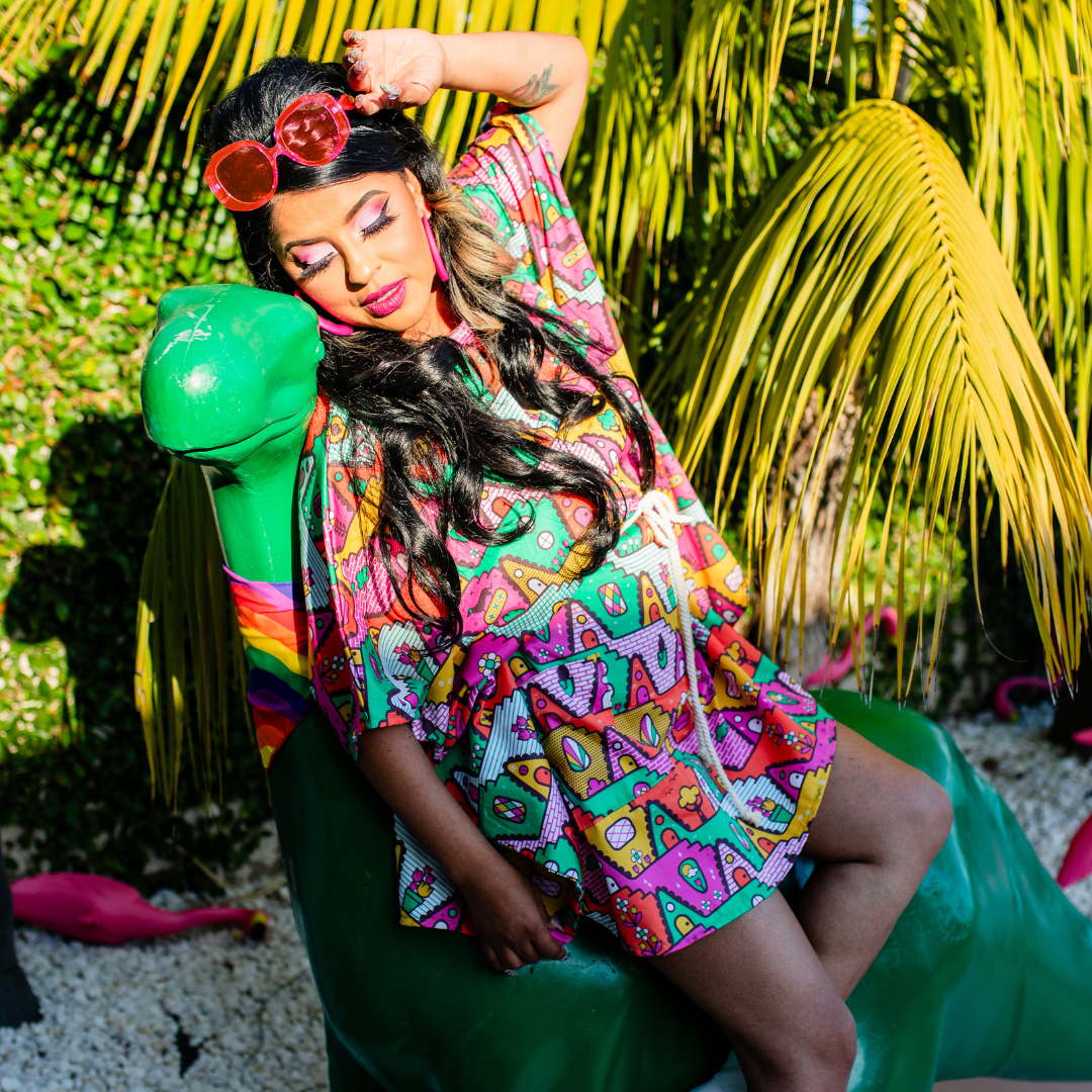 Pretty model relaxing in multicolor bold geometric print mini muumuu in the sun