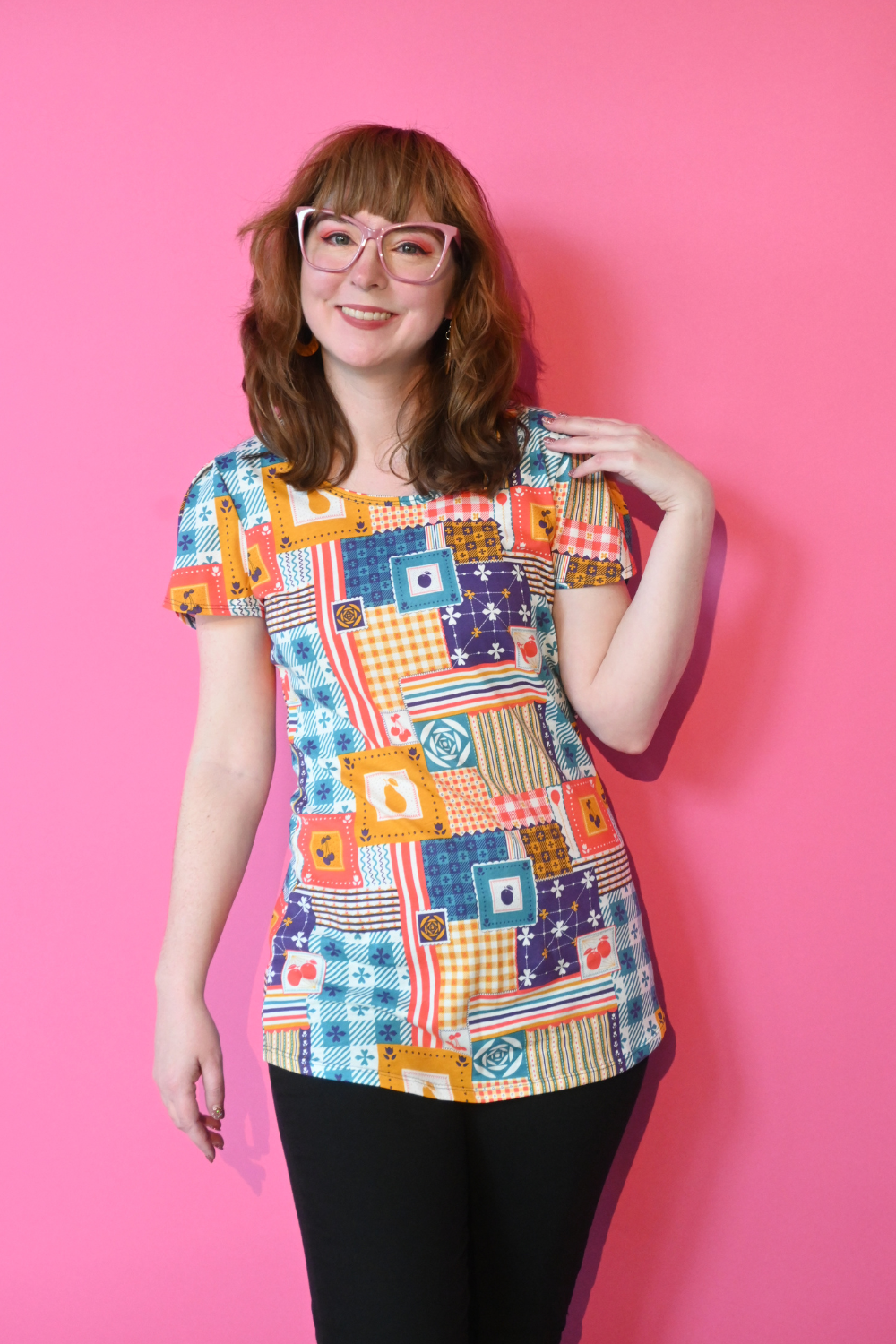 Brown-haired model with glasses in shirt printed with patchwork and fruit print