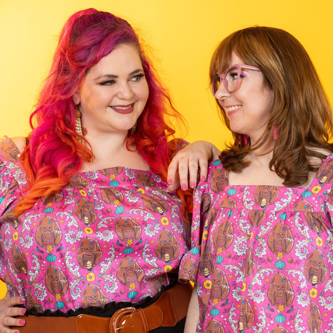 2 models wearing square-necked coconut monkey shirts