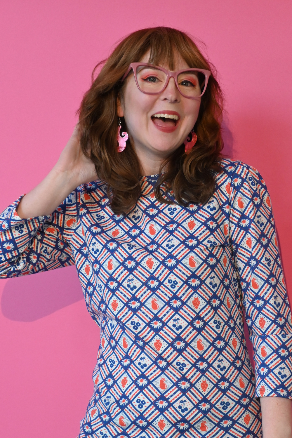 Navy blue red fruit flower plaid graphic tee on brown-haired model in glasses