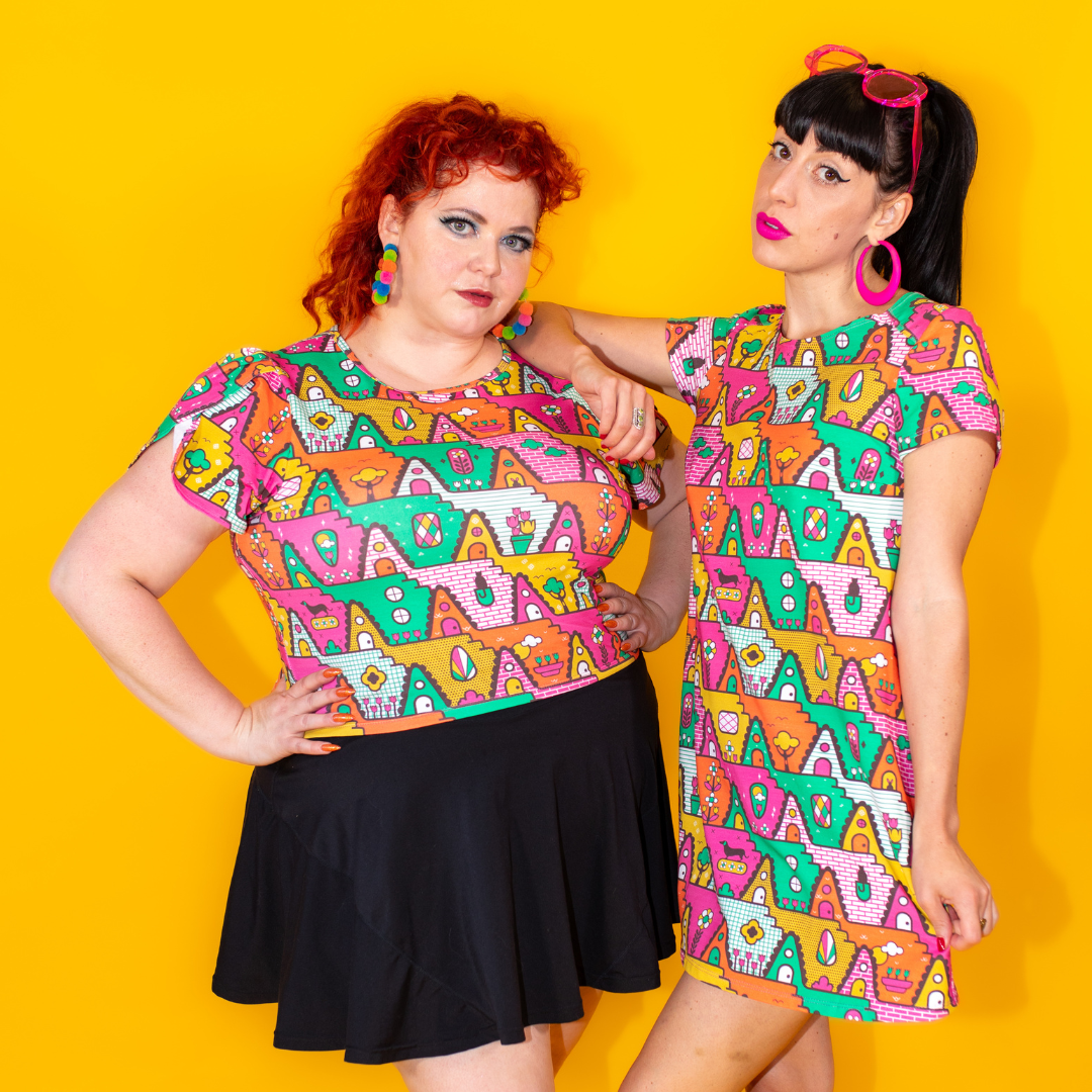 Closeup of 2 models wearing comfy knit clothing in matching bold geometric print