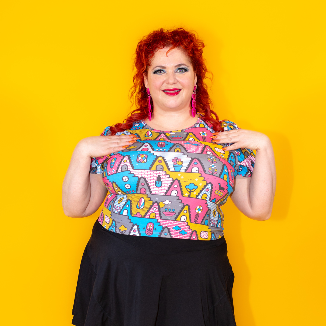 Closeup of plus sized red haired model in pastel geometric print tulip sleeved cropped tee