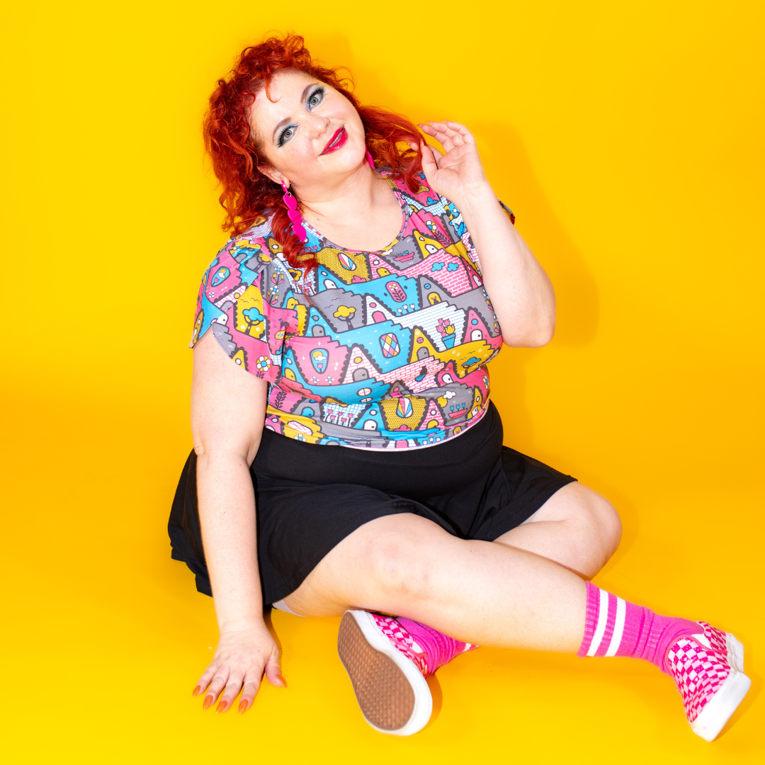 Plus sized red haired model in pastel geometric print tulip sleeved cropped tee