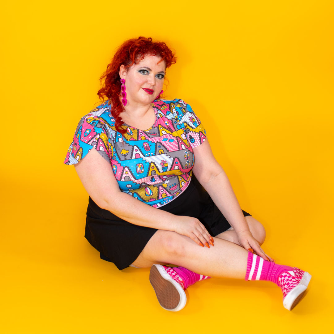 Plus sized red haired model in pastel geometric print tulip sleeved cropped tee