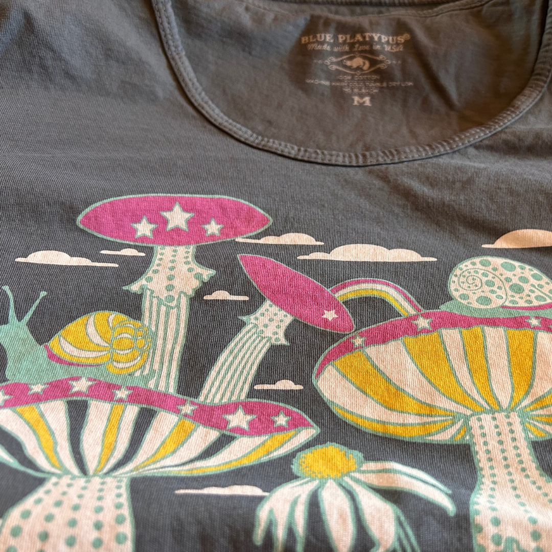 Closeup of grey tshirt with mushrooms and snails