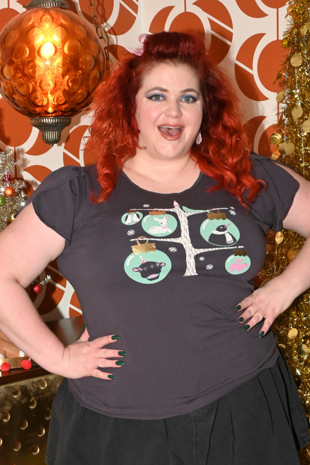 Plus sized happy model in holiday themed dark grey t-shirt