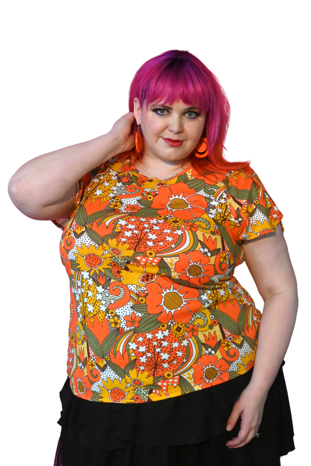 Pink-haired young woman wearing bright colored tee with large floral print