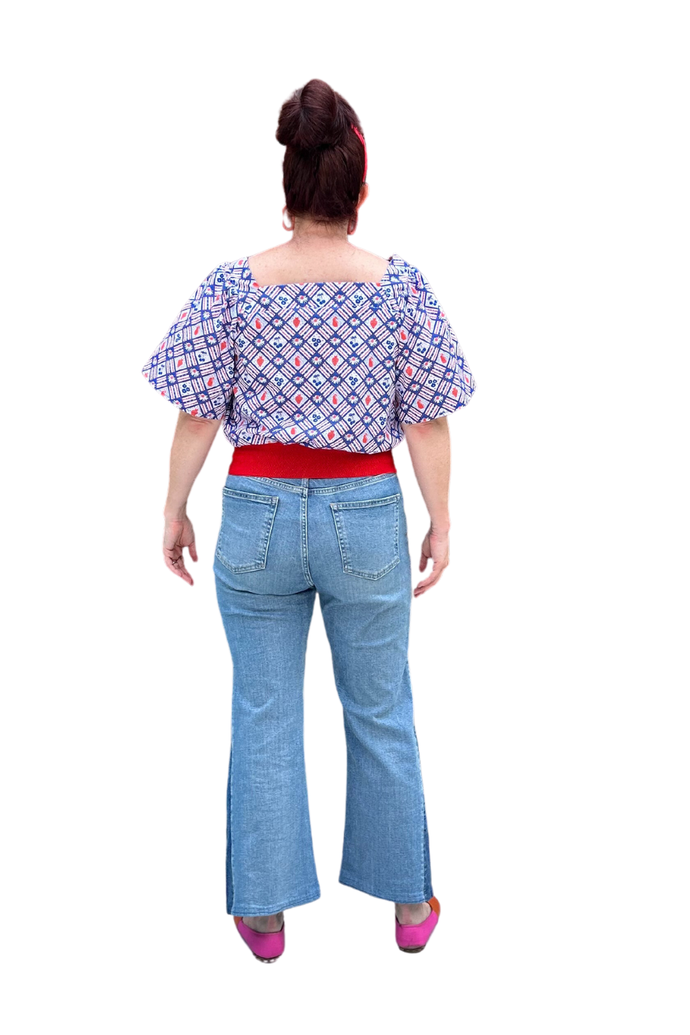 Back of square neck peasant top with blue and red print and graphic of fruit and flowers