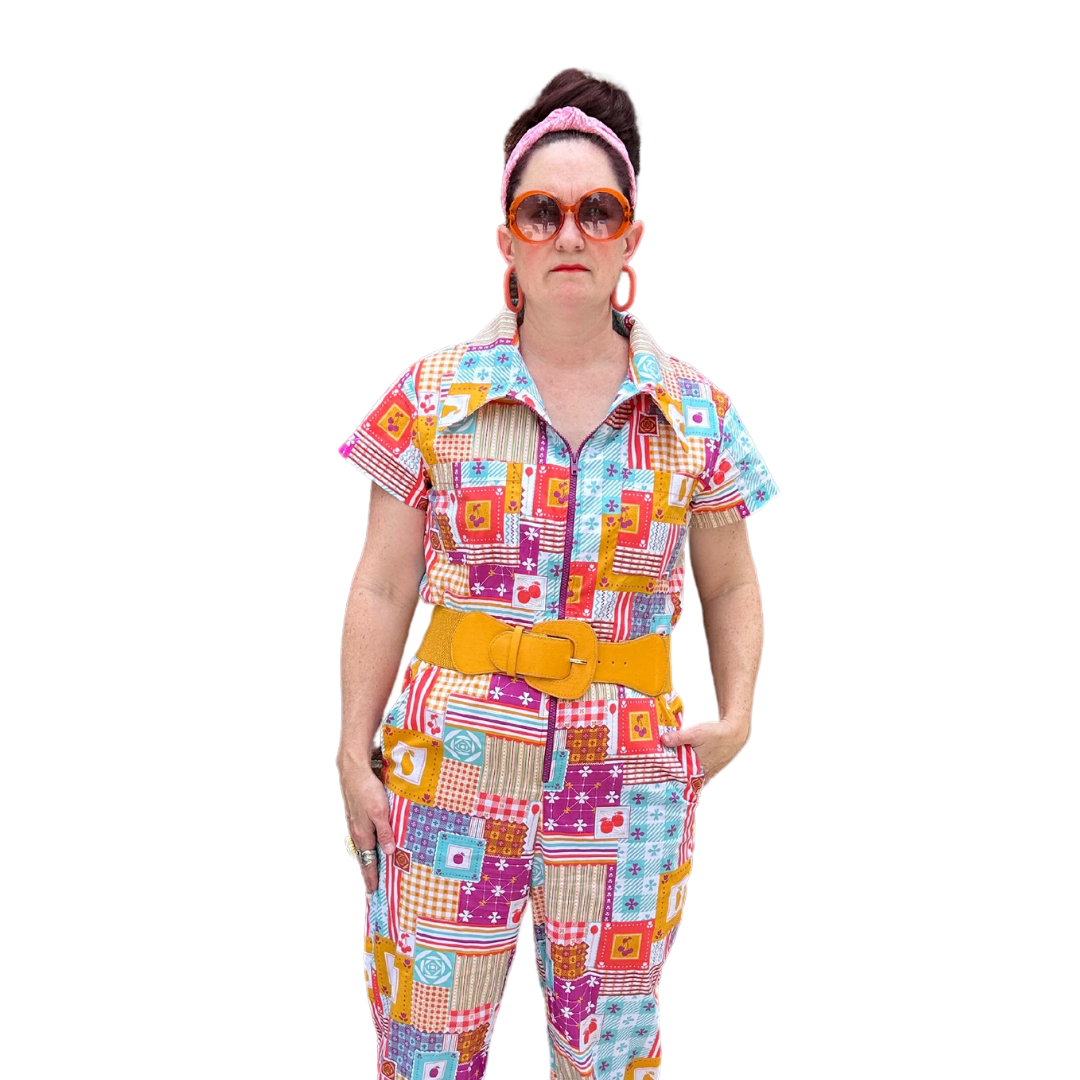 Model wearing sunglasses and patchwork print zip-front collared jumpsuit