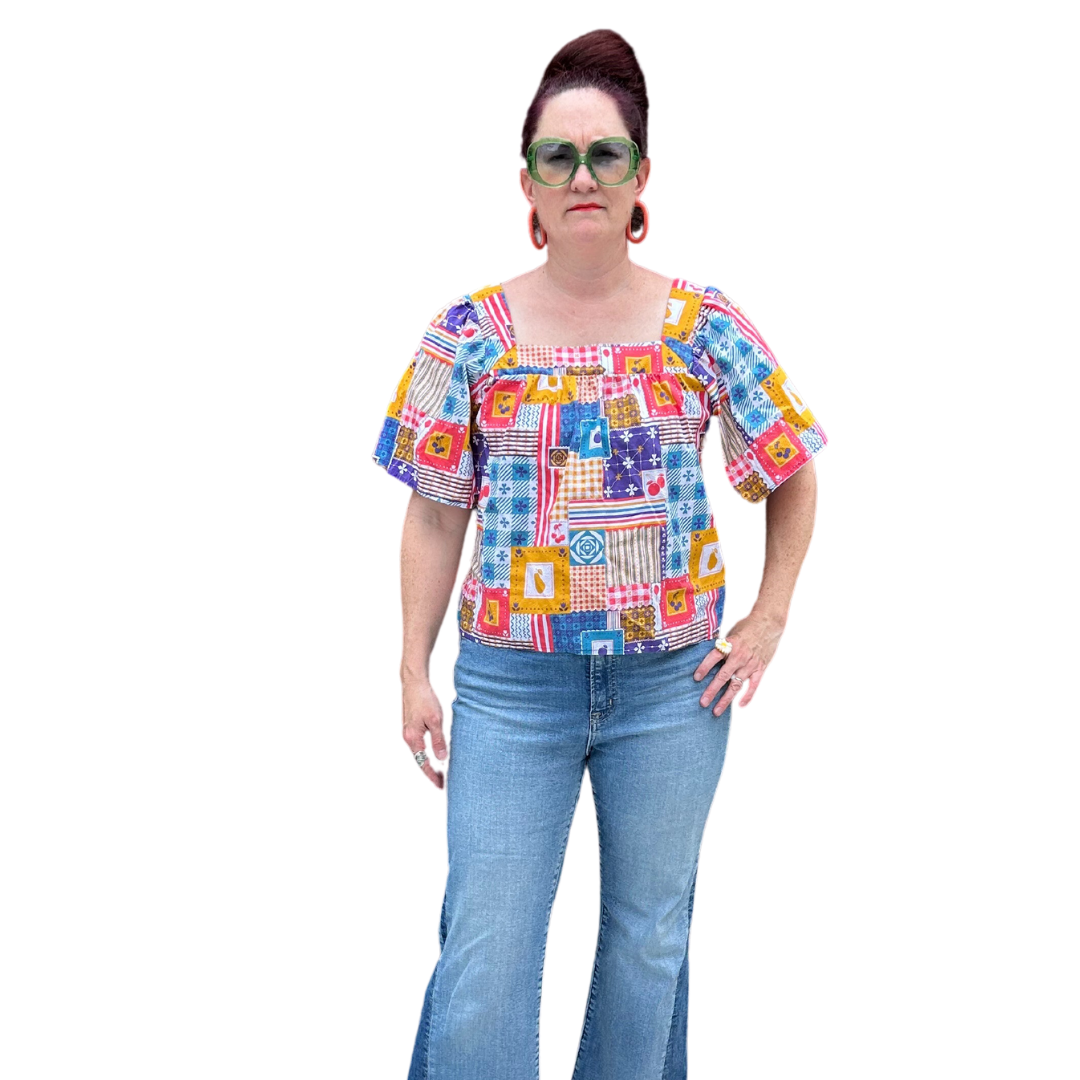 Model in blue red yellow patchwork print square neck top and jeans