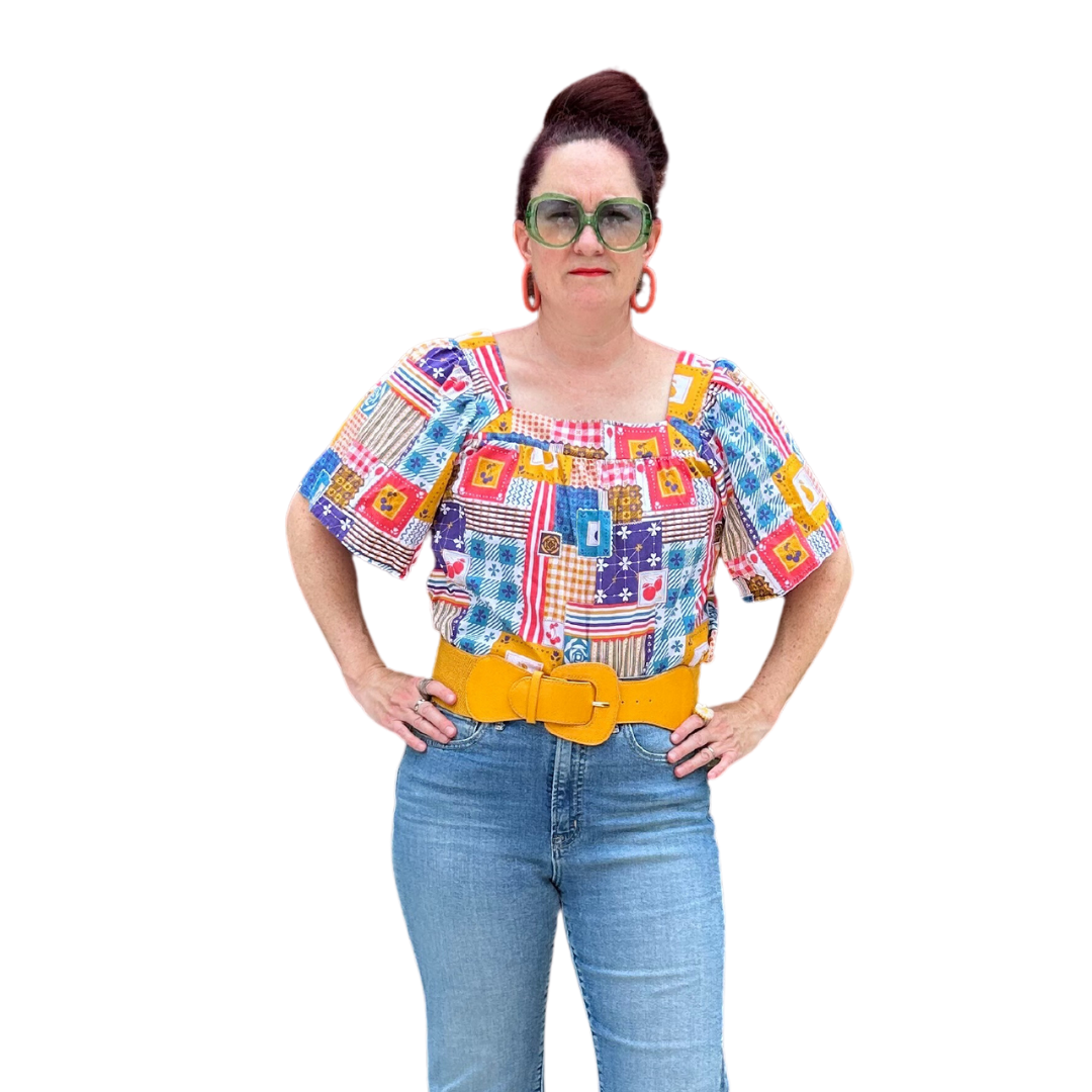 Model in blue red yellow patchwork print square neck top and jeans
