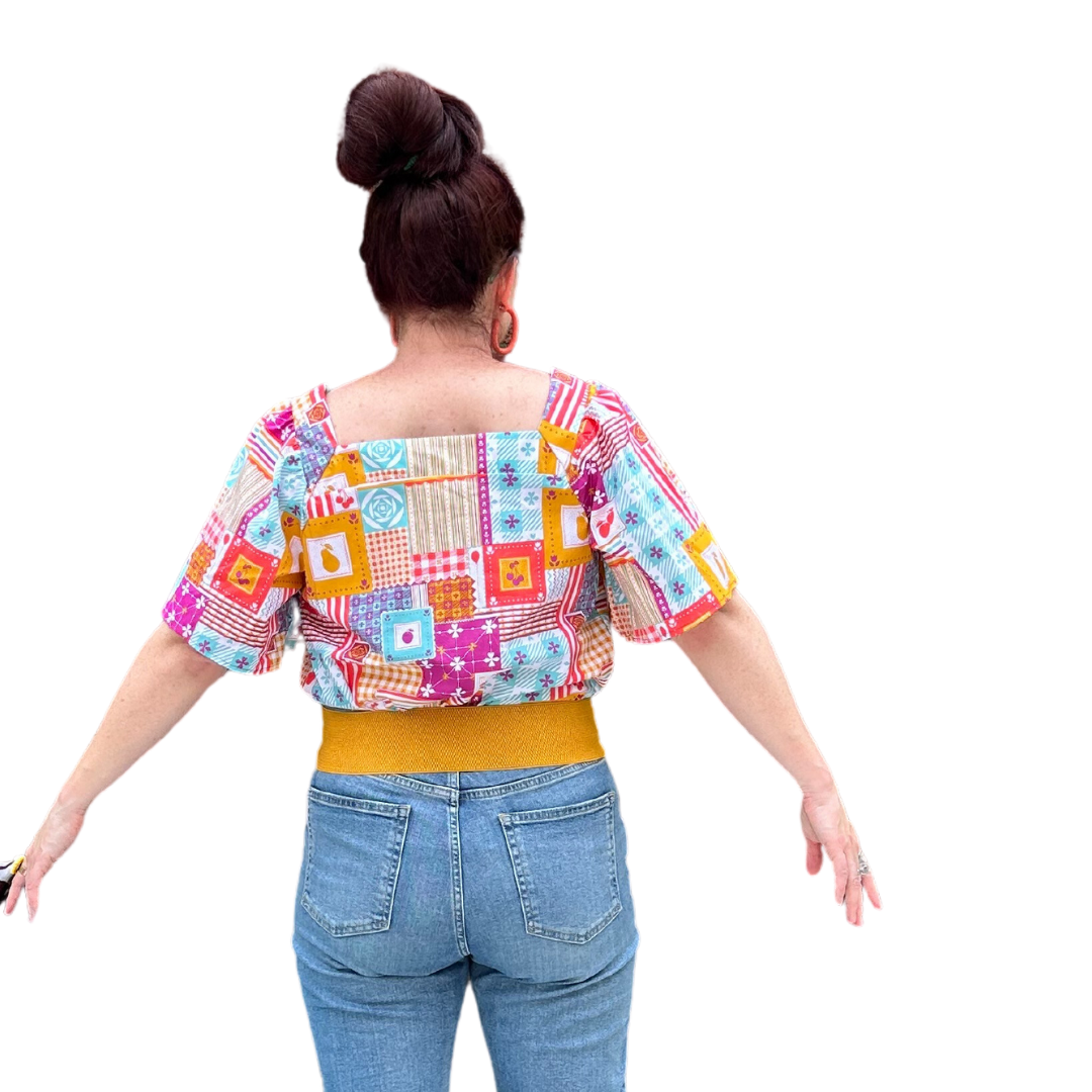 Back view of model in square neck patchwork print peasant top and jeans