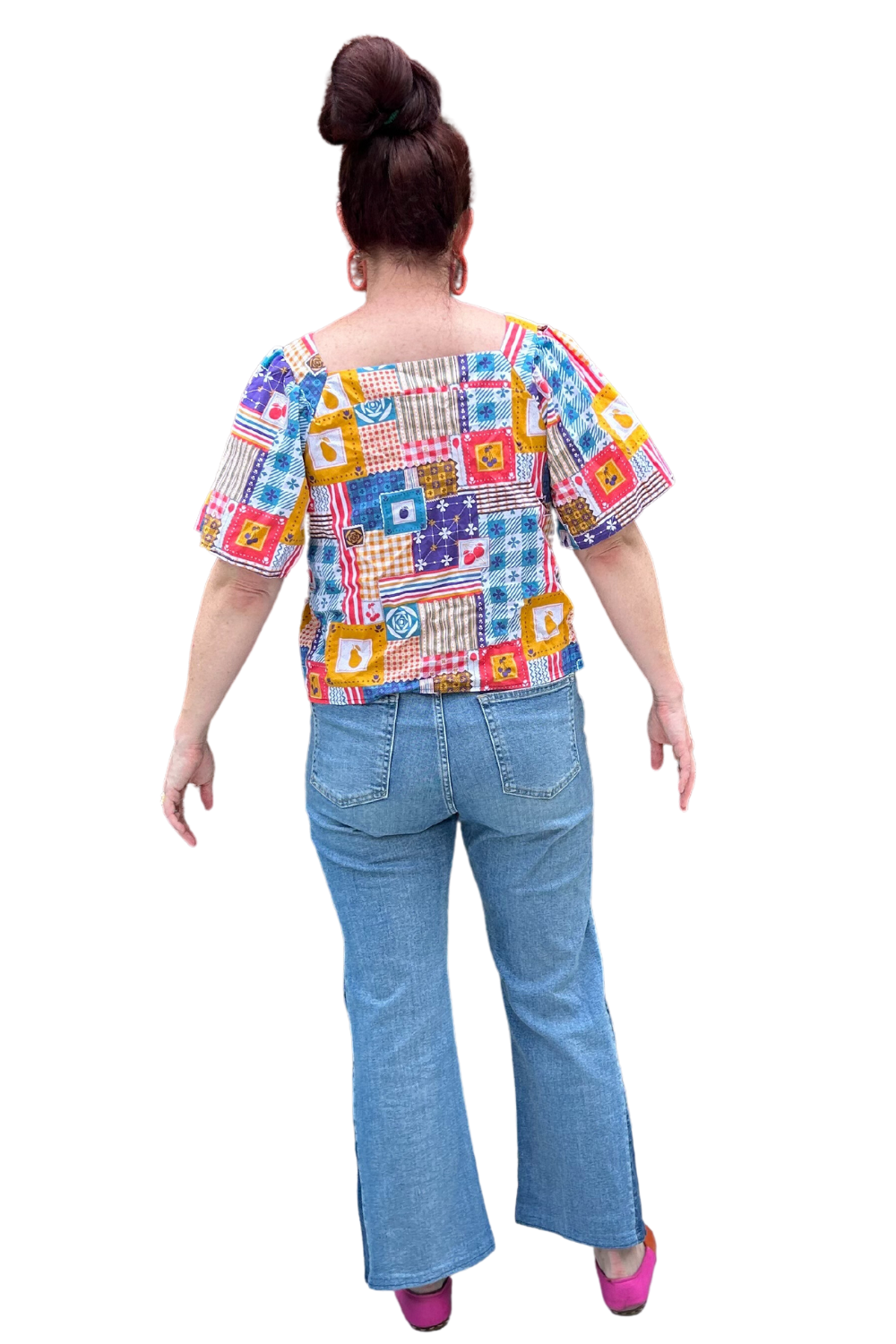 Model in blue red yellow patchwork print square neck top and jeans, back view
