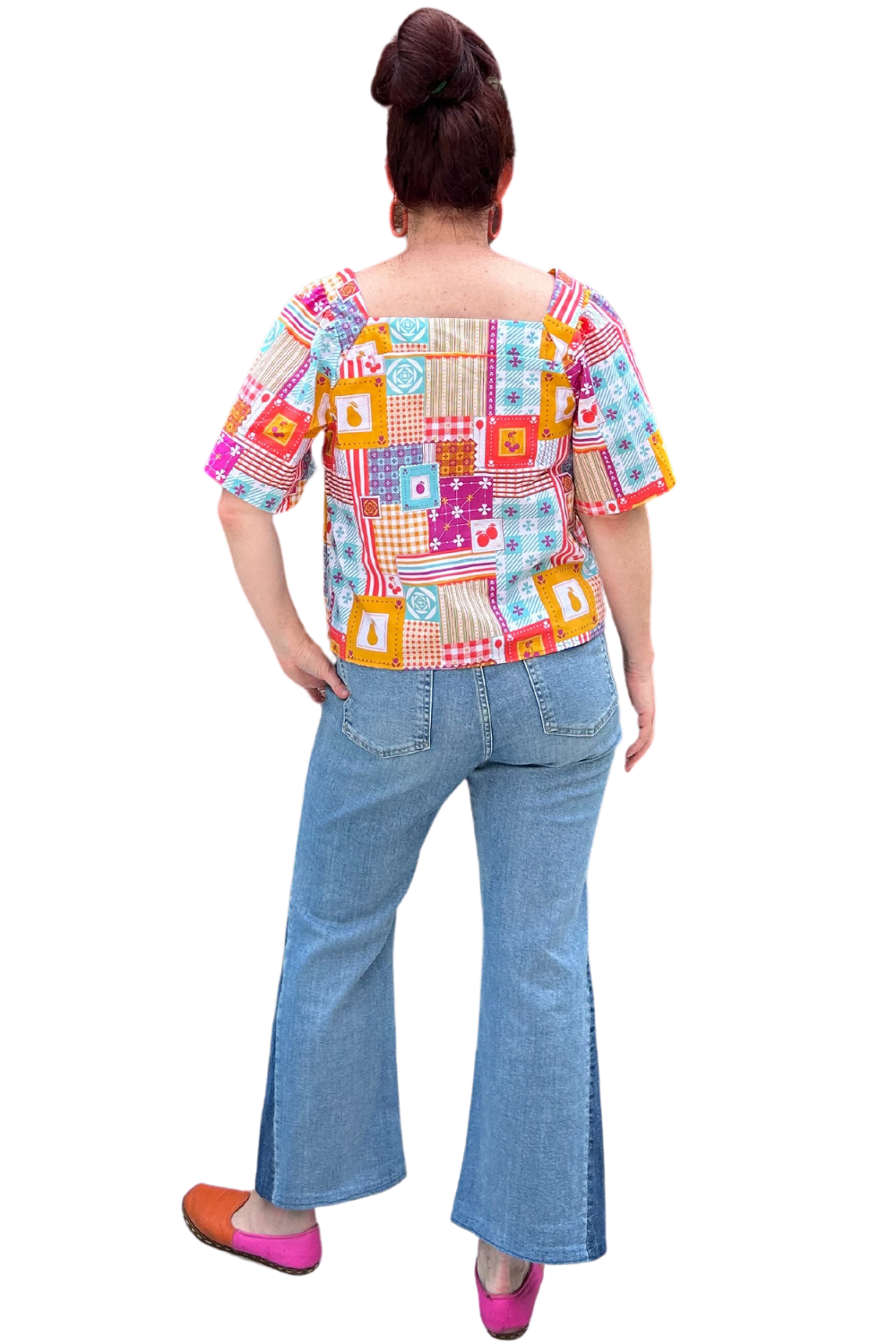 Back view of model in square neck patchwork print peasant top and jeans