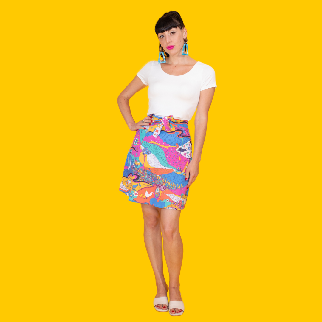 Pretty model wearing colorful landscape printed skirt with waist tie