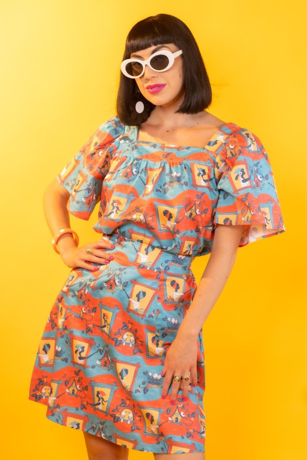 Pretty girl with bob haircut in matching printed shirt and skirt