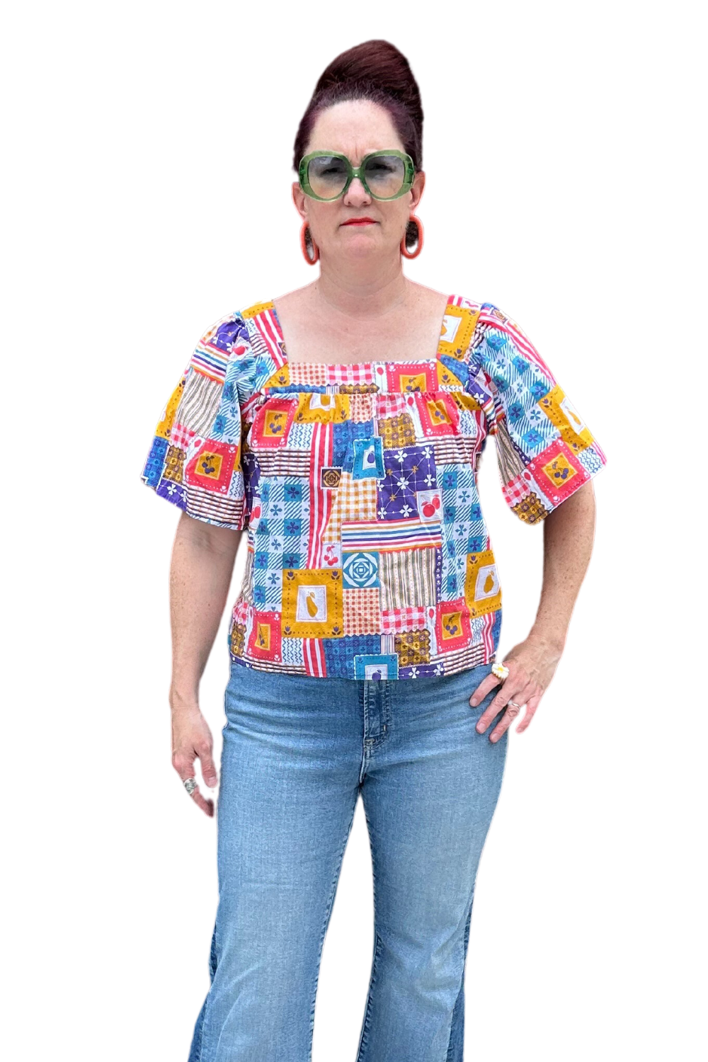 Model in blue red yellow patchwork print square neck top and jeans