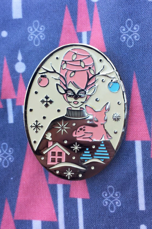 Pink and green pastel enamel pin with reindeer and a masked with with beehive hairdo