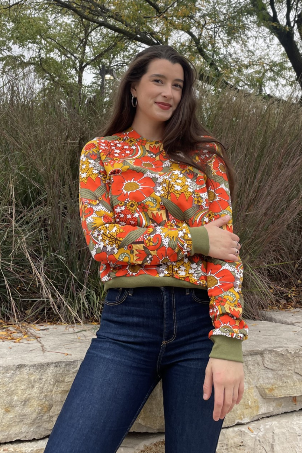 Long-haired tall model with big floral print cropped sweatshirt