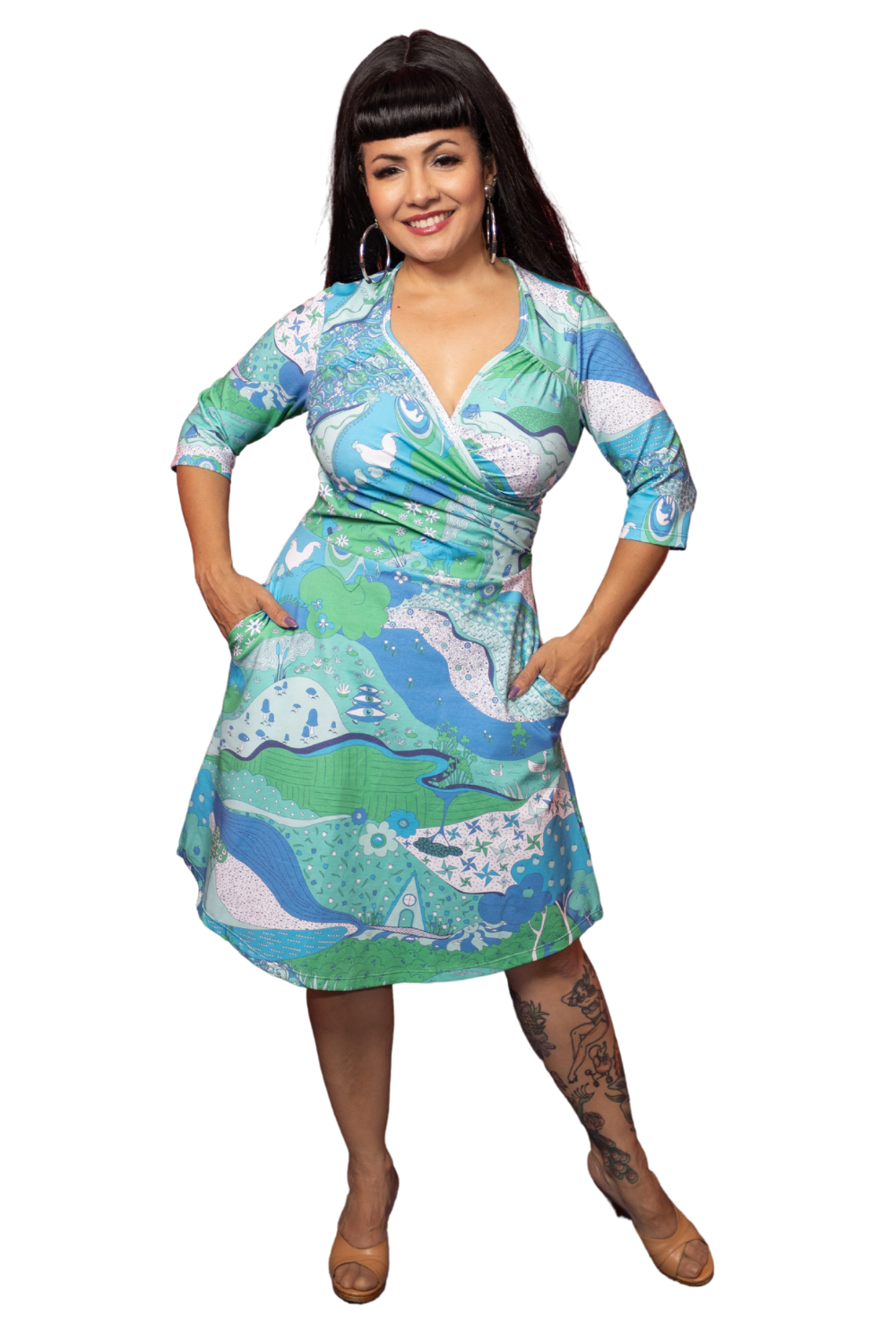 Cute black haired model in psychedelic wrap dress in shades of blue and green