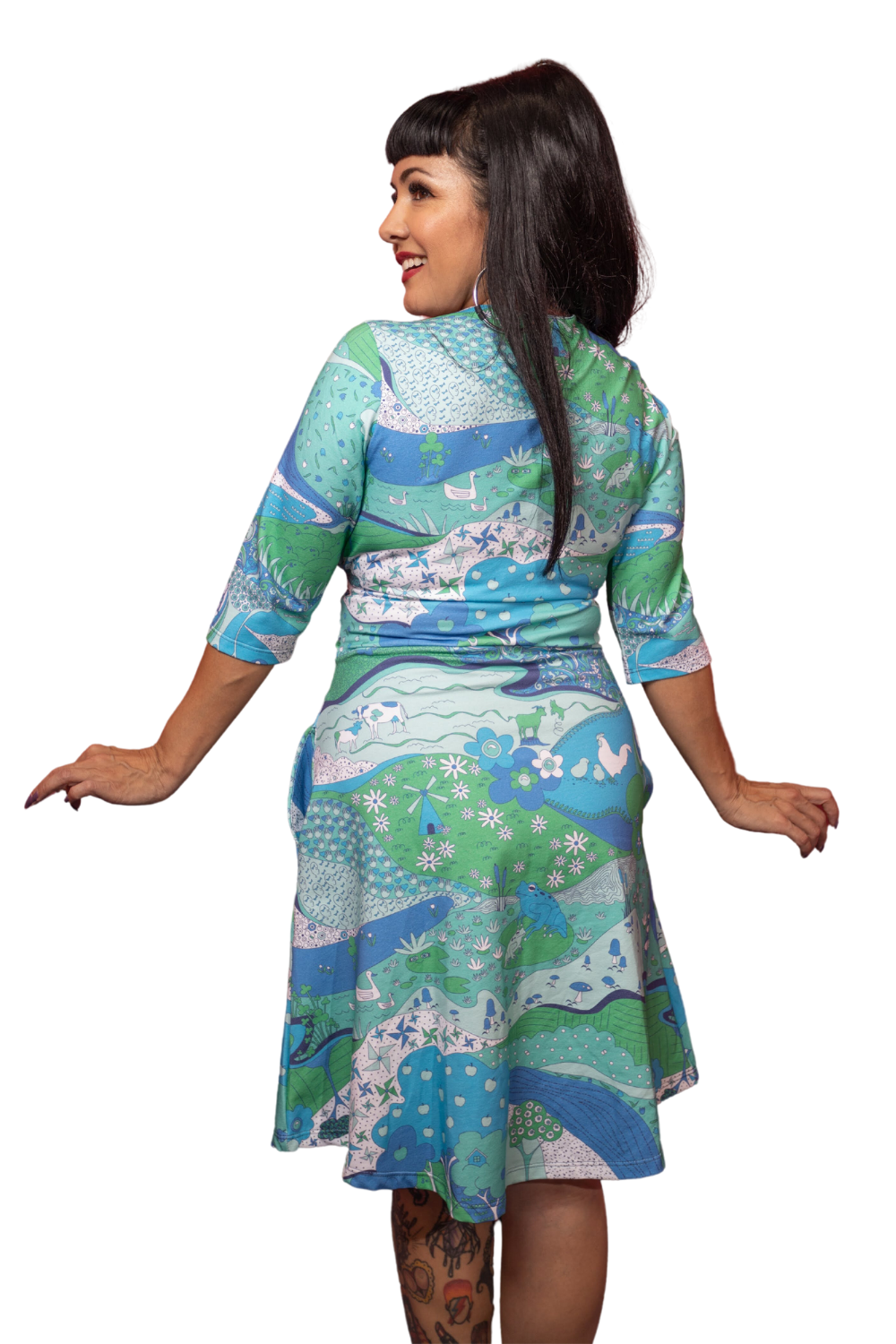 Back view of model in sweetheart wrap dress in psychedelic blue and green print
