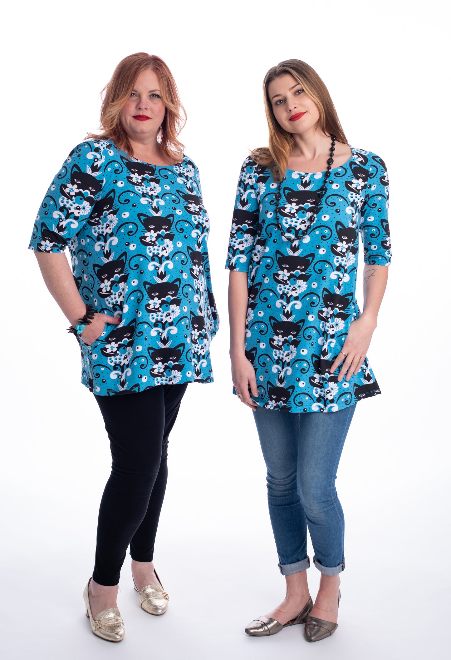 Aqua blue black white a-line pocket tunic with black cat and flower print on 2 models