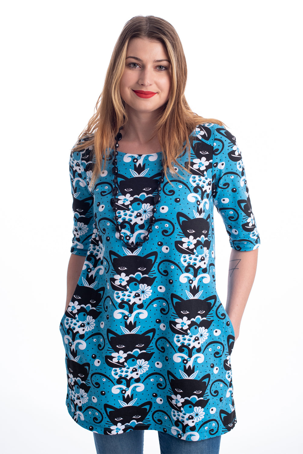 Aqua tunic with black and white cats and flowers on pretty model