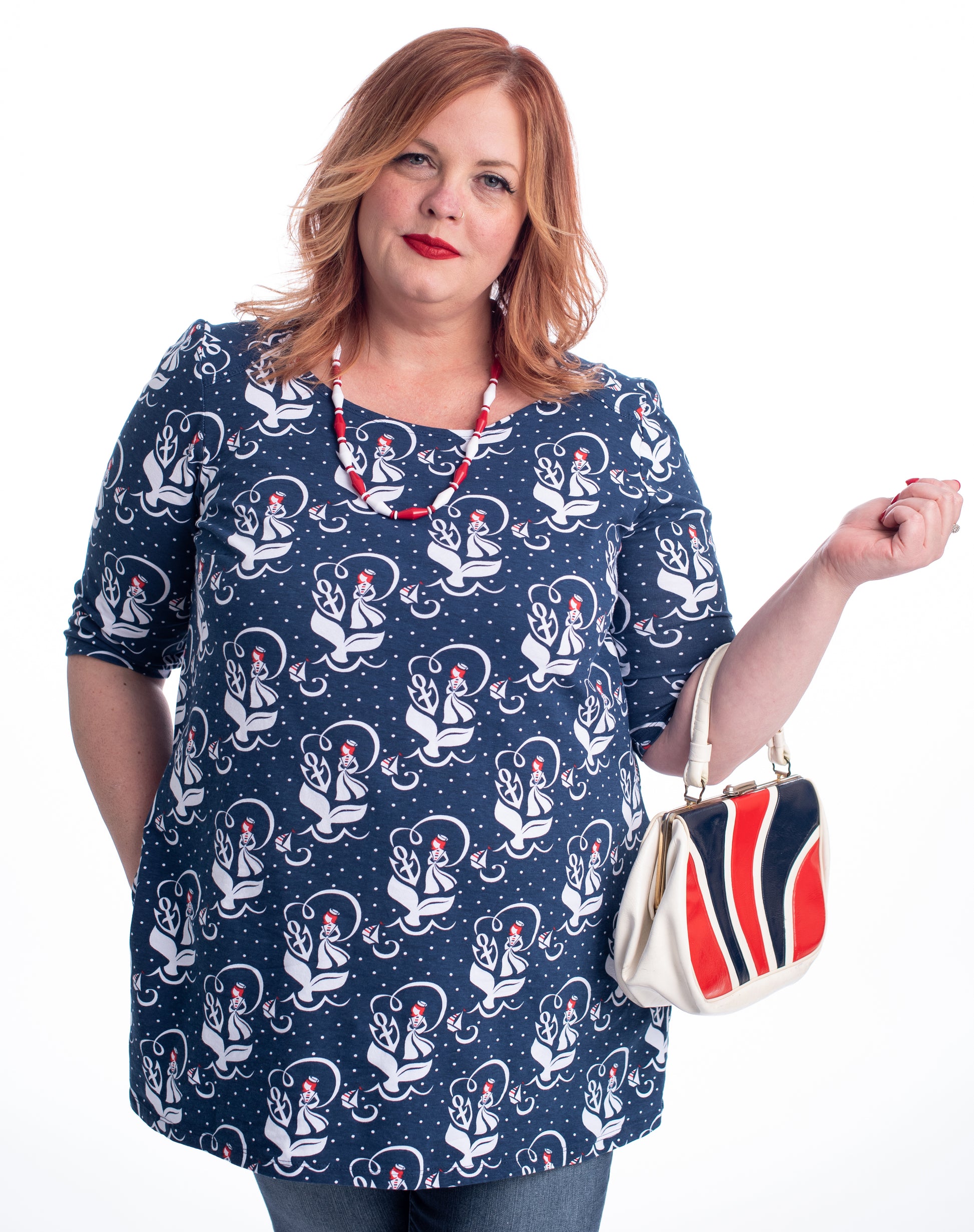 Red-haired model in navy, red and white sailor girl, anchor and whale tail print nautical pocket tunic