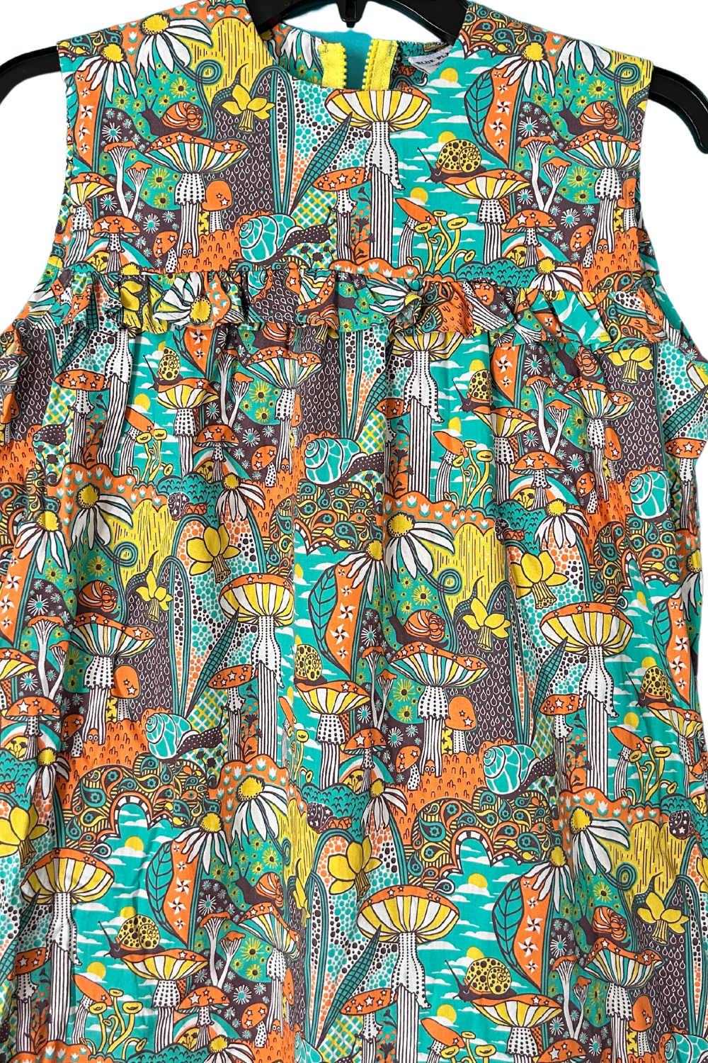Closeup of mushroom and snail print sleeveless maxi dress with ruffle above the bust