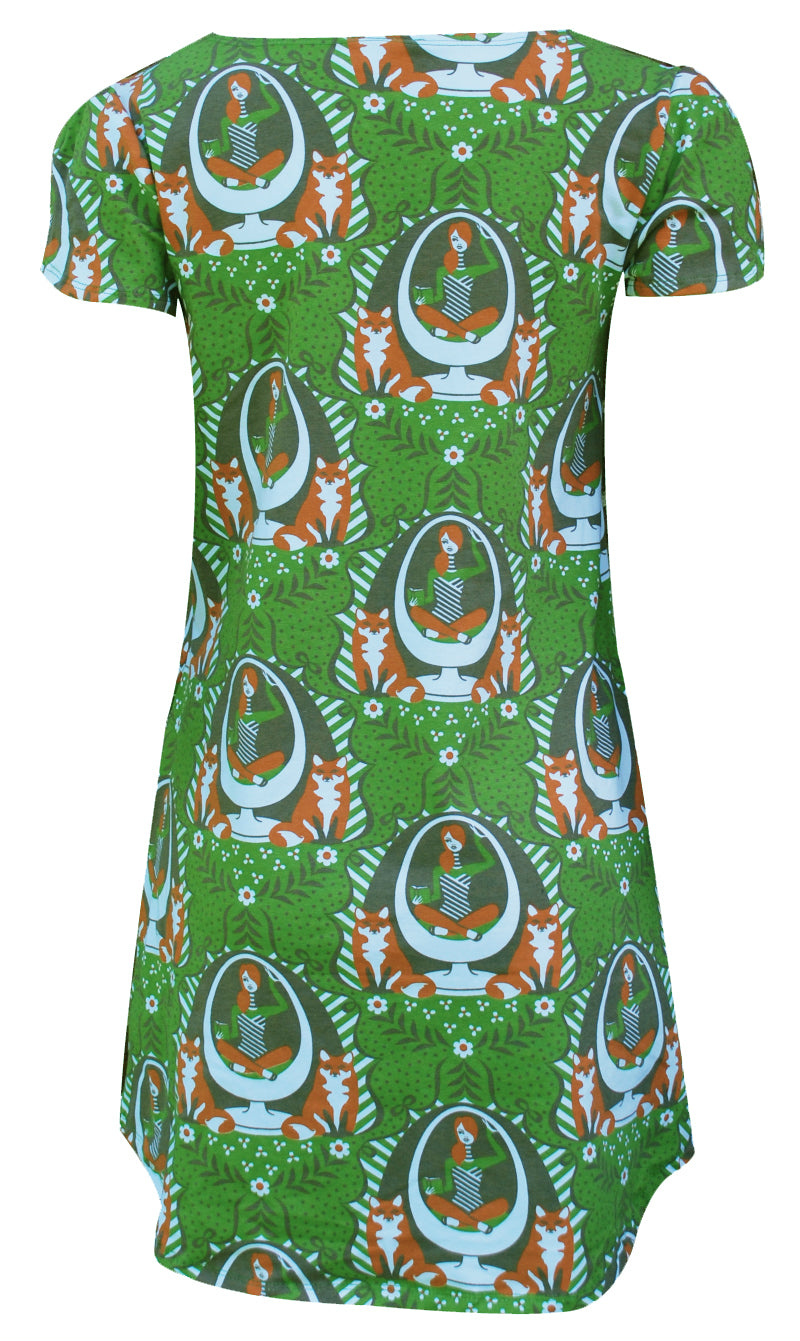 Back view of green tulip-sleeve tunic with print of girl reading in egg chair and foxes