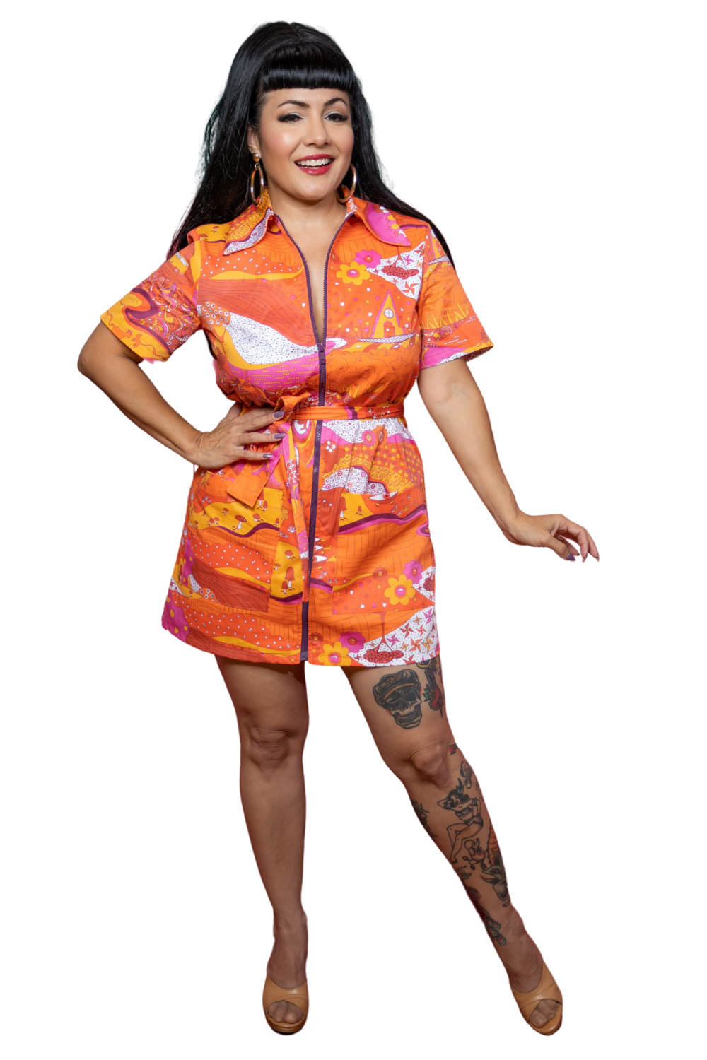 Model wearing pink, orange and yellow dress featuring a landscape graphic