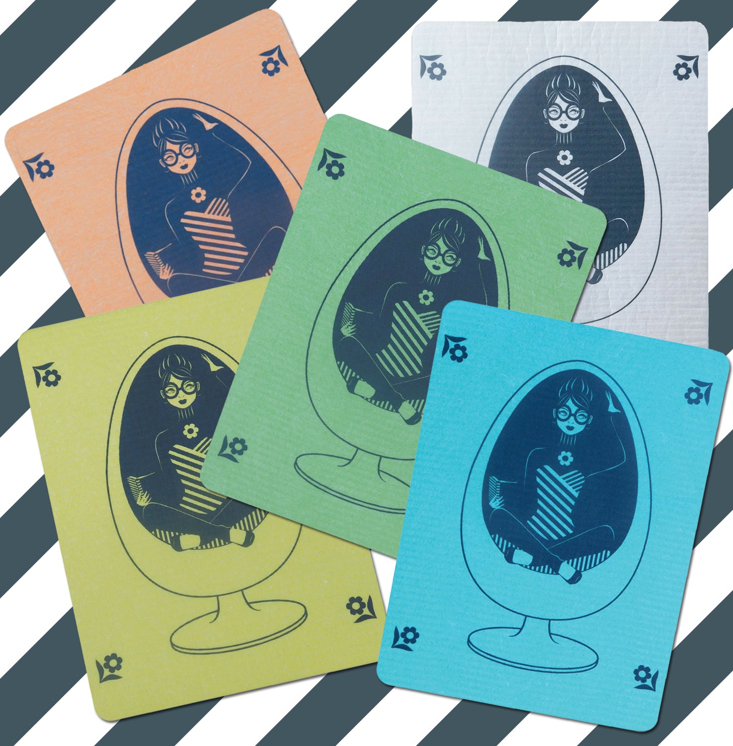 5 colorful Swedish dishcloths featuring our design of a girl in glasses reading in a vintage egg chair
