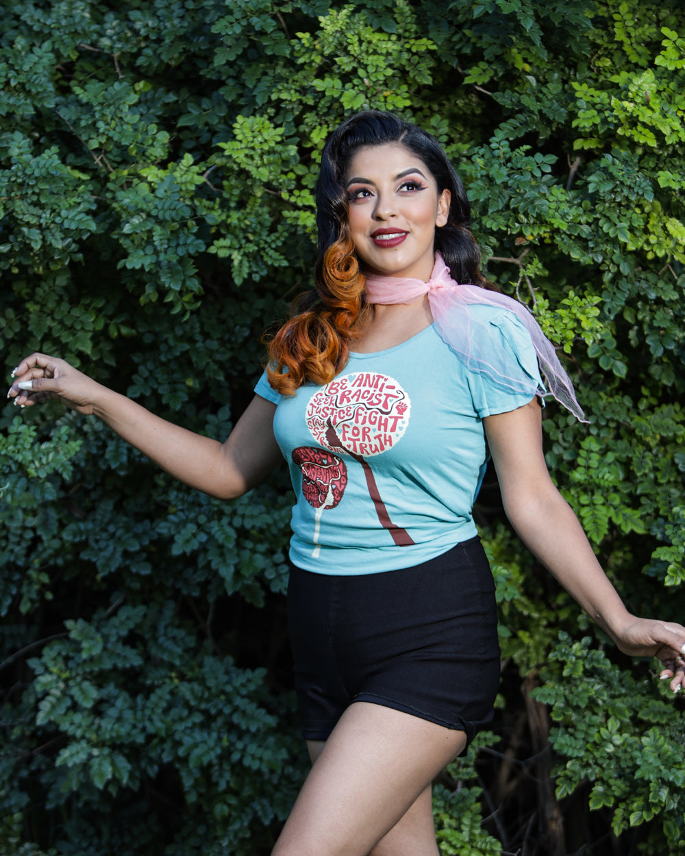Latina model wearing blue shirt with anti-racist messages