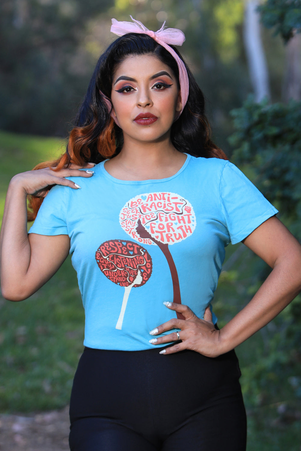 Light blue tee with design of afro girls or flowers with anti racist messages