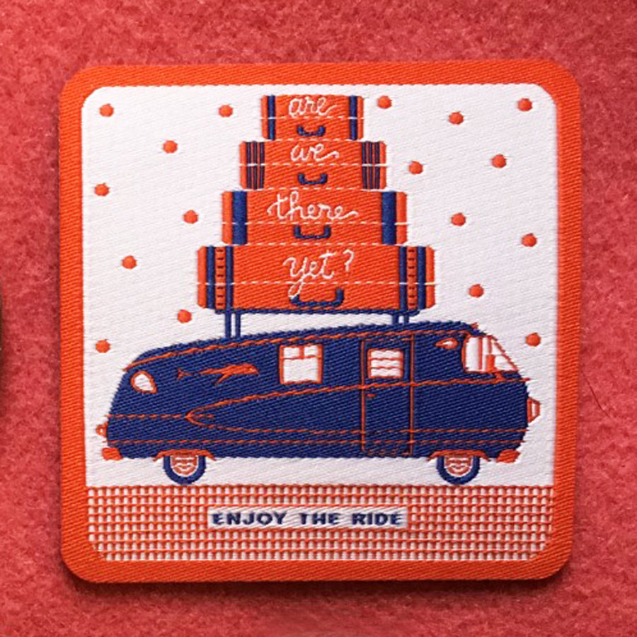 Iron on patch featuring navy blue motorhome, suitcases on top, and Enjoy the Ride with red polka dots and border
