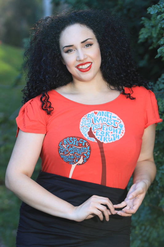 Curly-haired model with red shirt bearing anti-racist messages