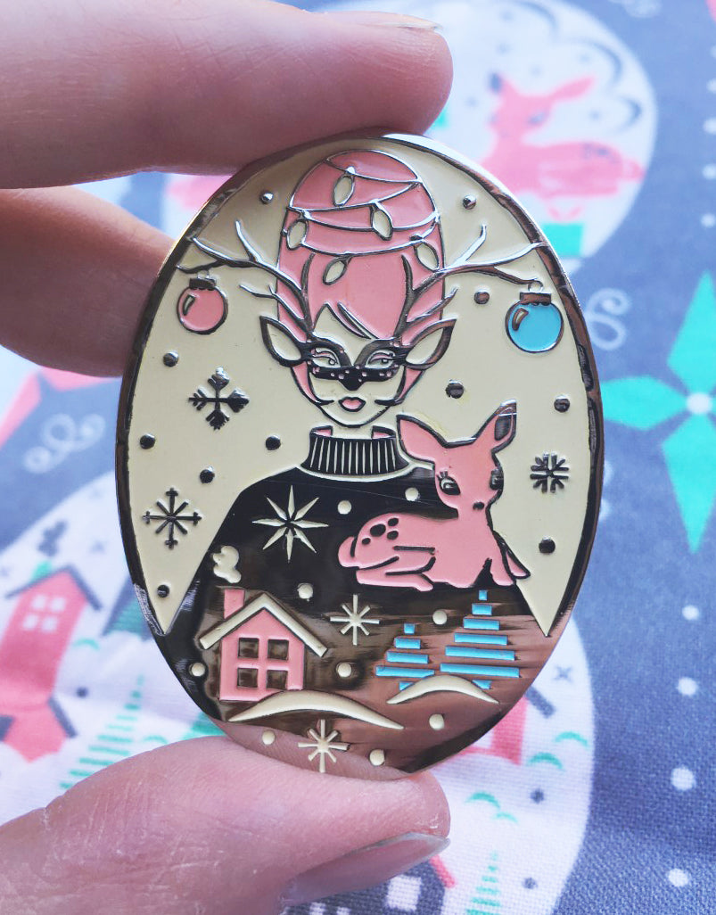 Pink and green pastel enamel pin with reindeer and a masked with with beehive hairdo