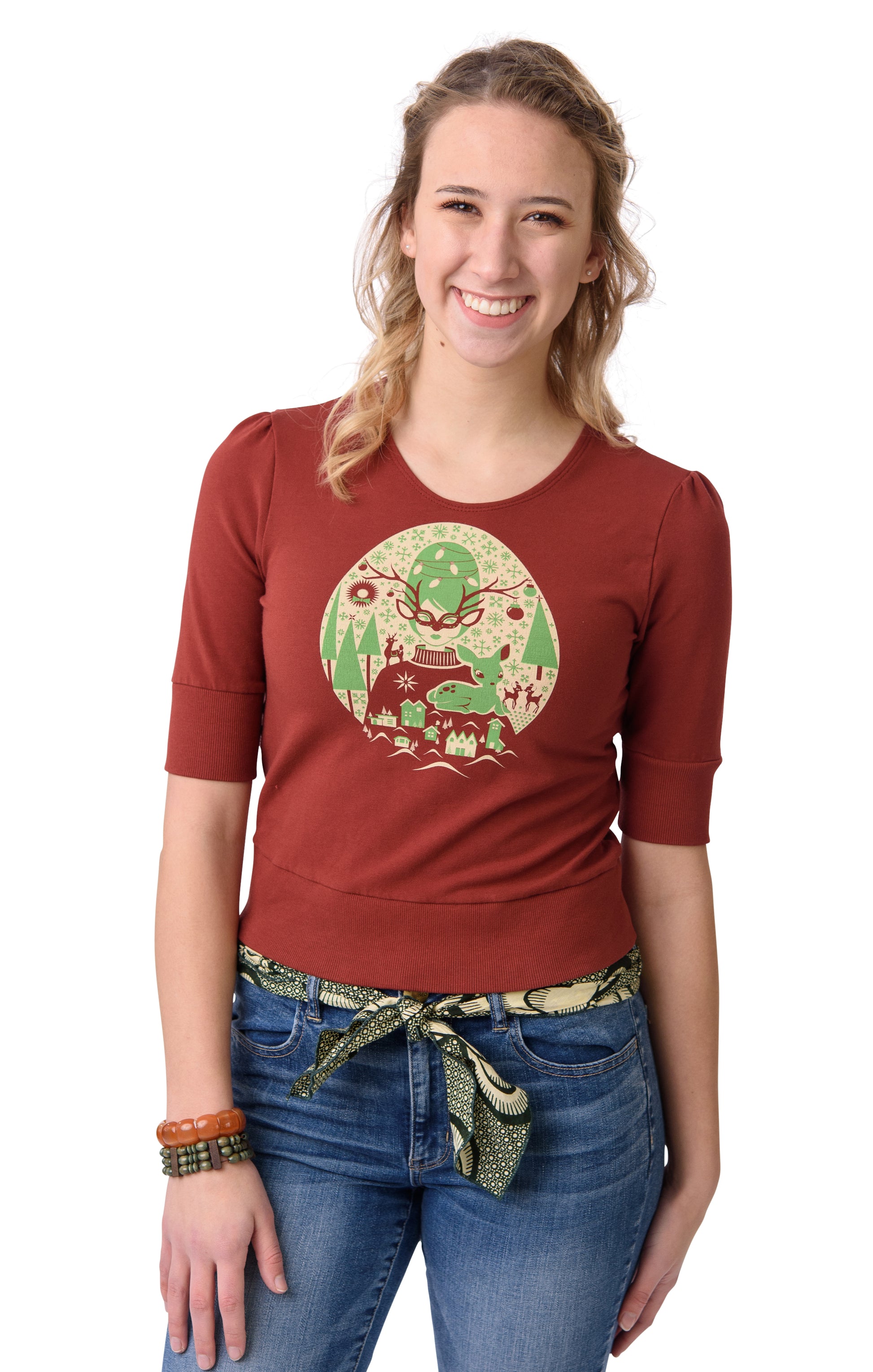 Rust- colored cropped French terry tee with bright green and off white screen print of masked girl with snowflakes on model 
