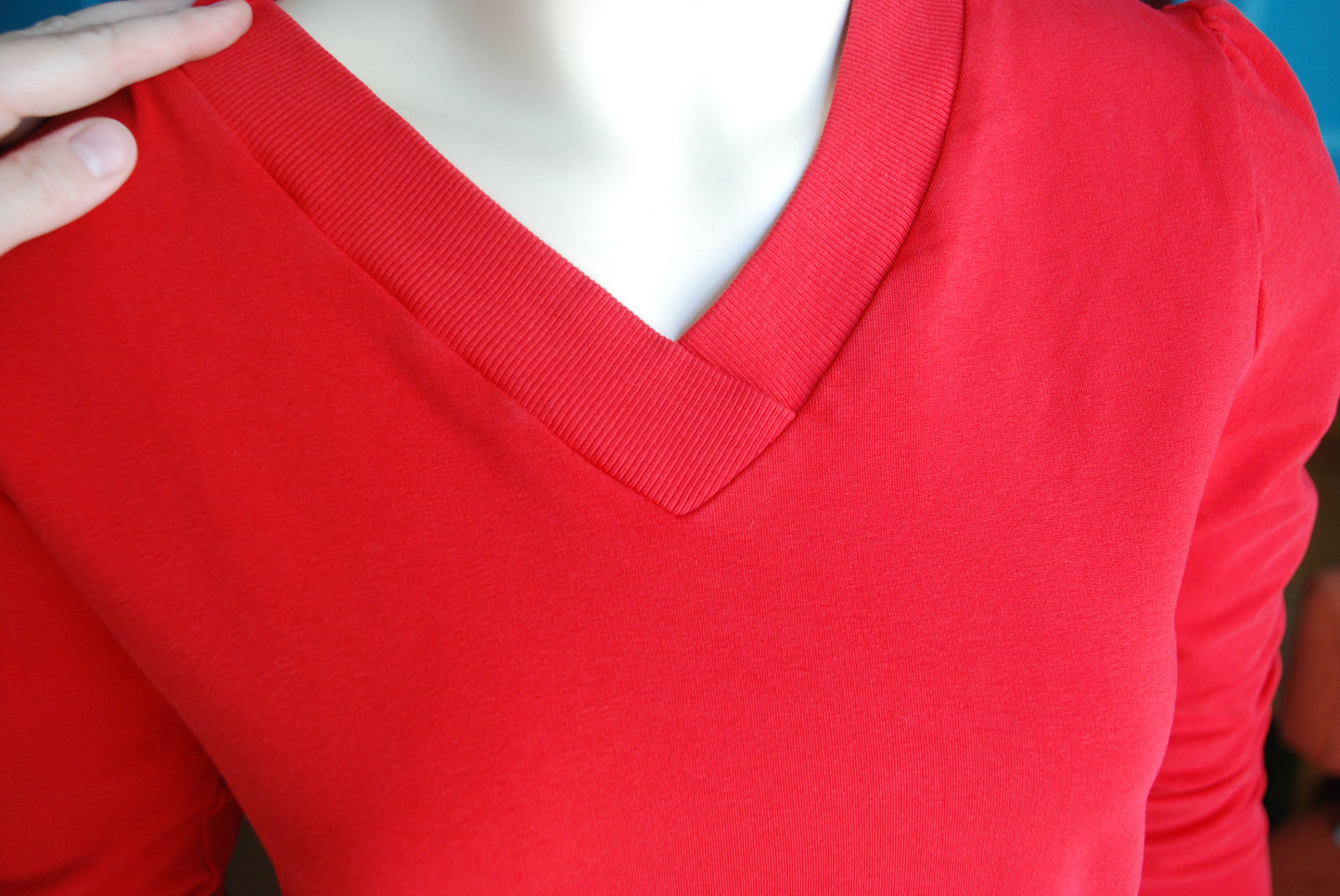 Closeup of red French terry v-neck top