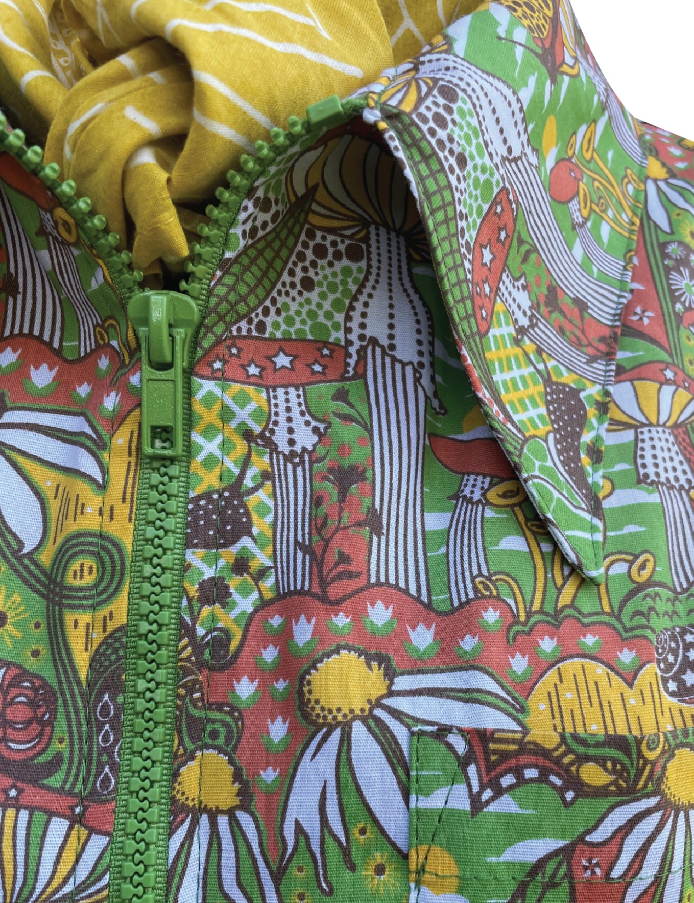 Closeup of olive green, orange and yellow mushroom print jumpsuit