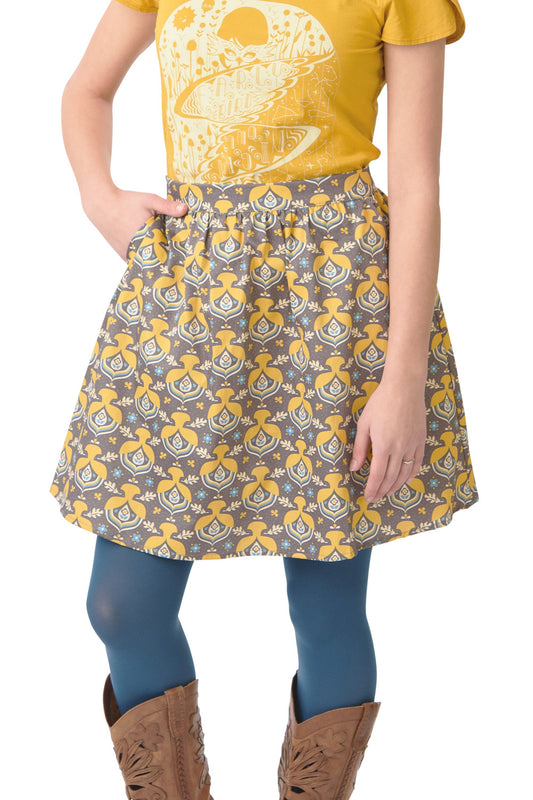 Grey dress with yellow acorns and blue accents