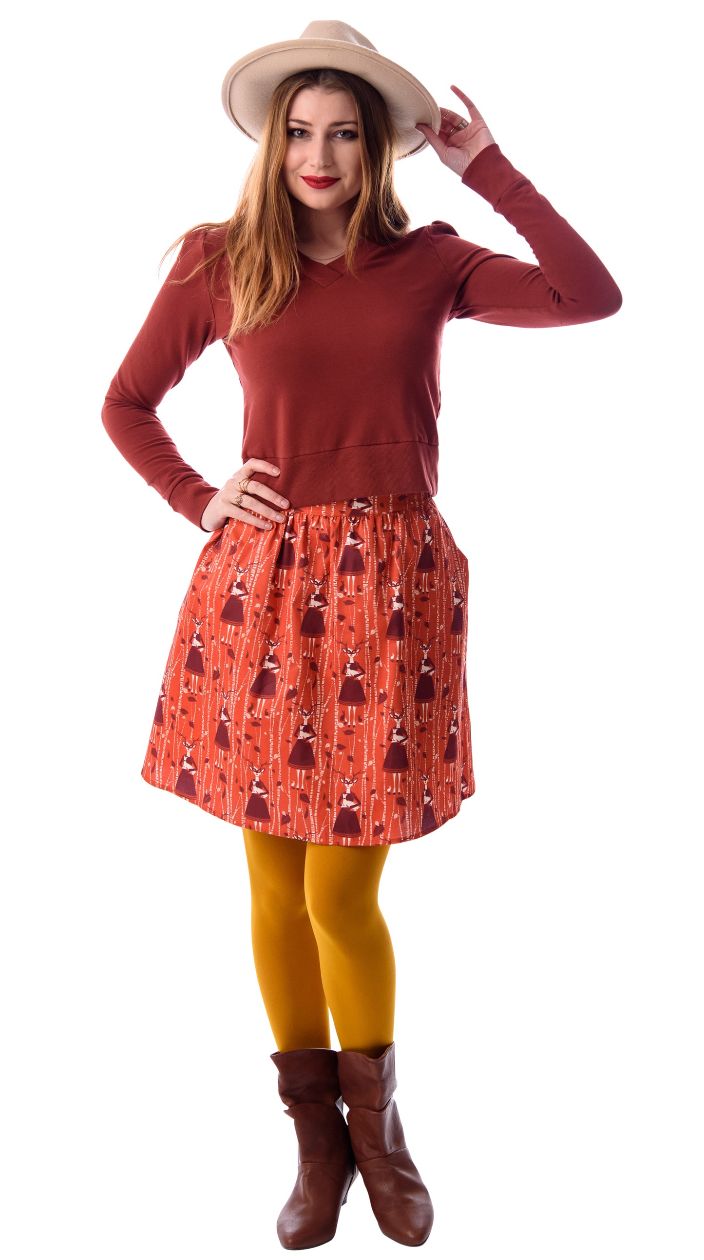 Orange and brown skirt with deer, birches and masked girl print and pockets