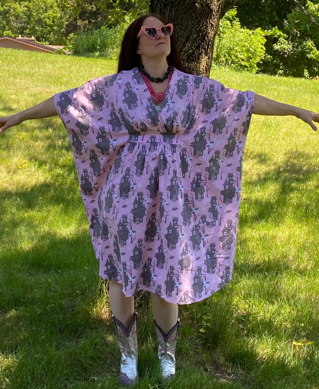 Silly person in pink and grey haunted house print caftan dress