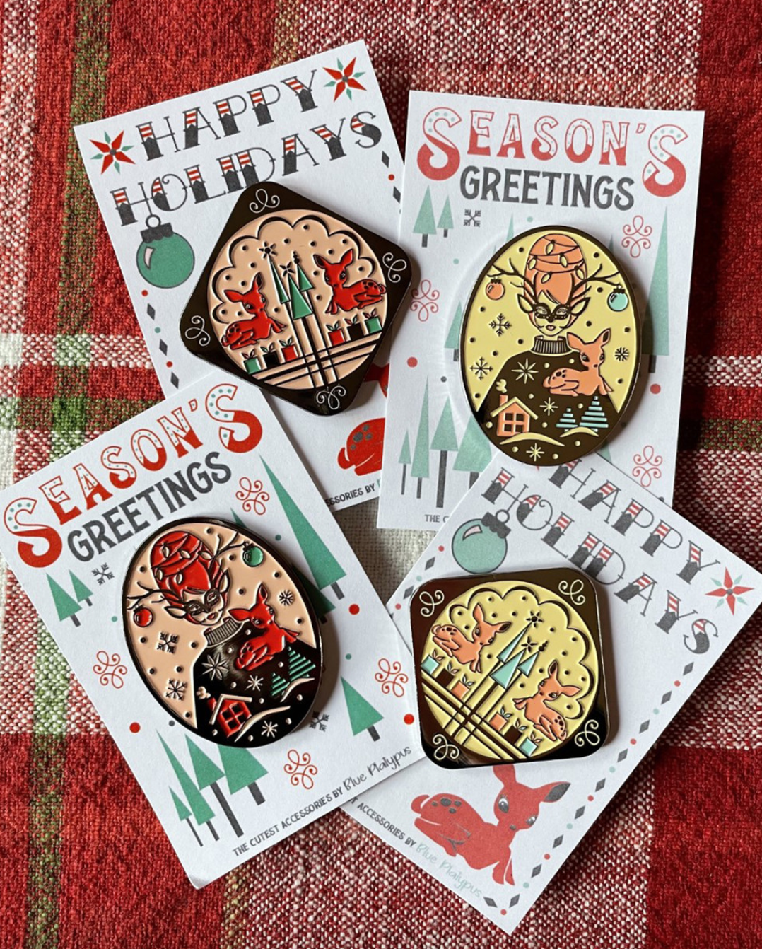 Set of 4 vintage holiday themed pins with reindeer, pine trees, gifts and putz houses