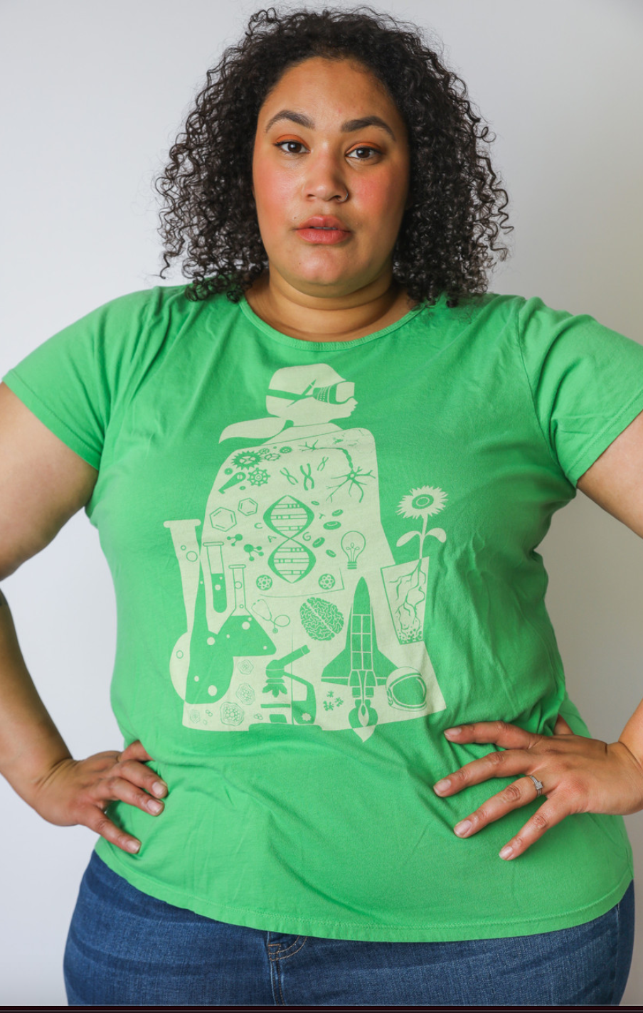 Closeup of bright green crewneck tee with white graphic of scientist, DNA, and rocket on model